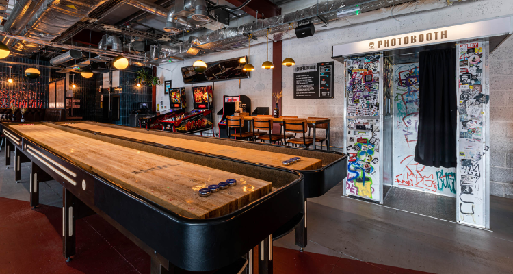 Gaming area at BrewDog DogTap Aberdeen, with shuffleboard tables and a photobooth.