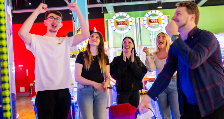 Group of people playing an arcade game Funstation Glasgow.