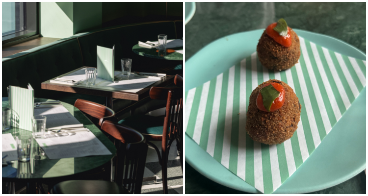 Dappled sunlight coming across tables at Lina Stores Manchester and two breadcrumbed and fried balls of aubergine on a blue-green plate.