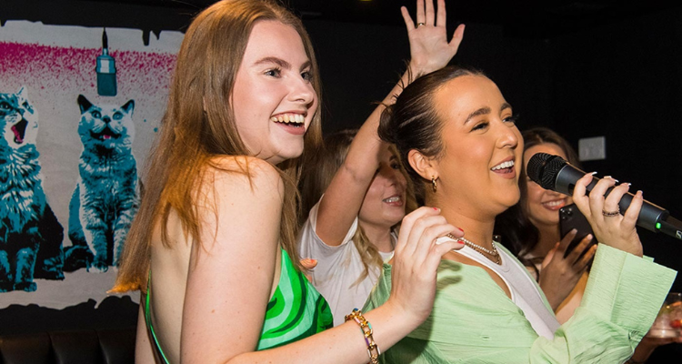 Girls singing karaoke at Boom Battle Bar Sheffield.