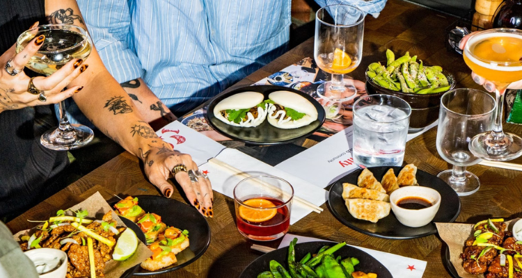 Friends at table eating Wagamama.