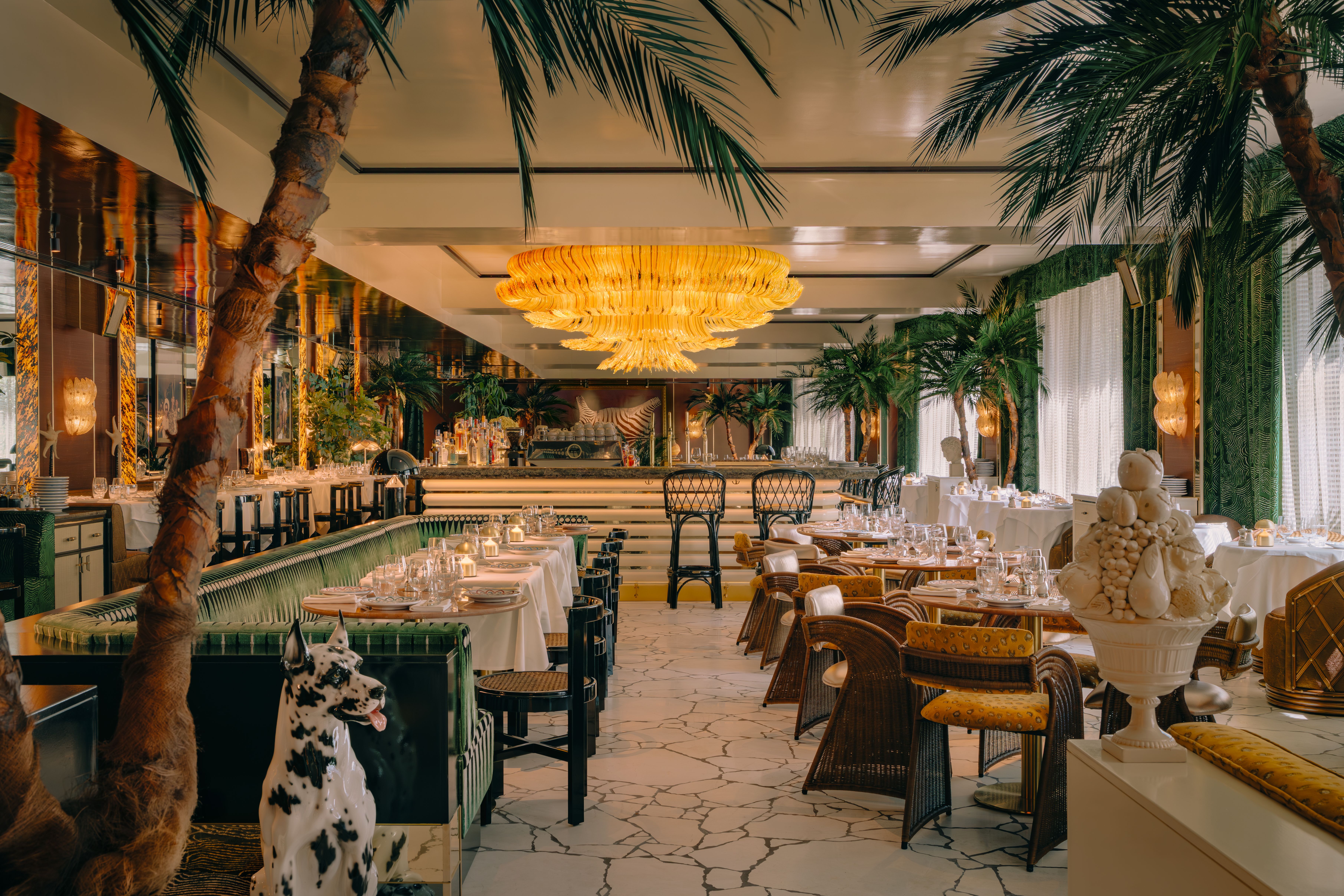 Interior image of Barbarella in Canary Wharf, showcasing dining tables and chairs with flamboyant decor.