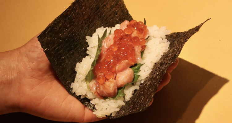 Sushi rice, salmon and roe sitting inside nori sheets, ready to be rolled into sushi, at Nishiki Edinburgh.