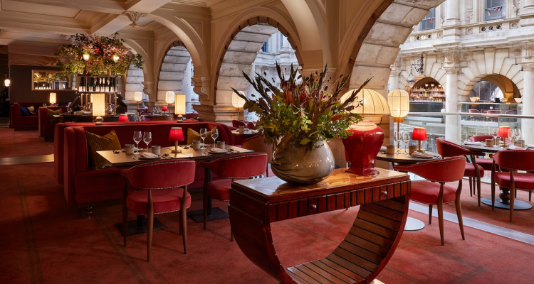 Interiors of Jang London, featuring red velvet armchairs and grand ceilings.