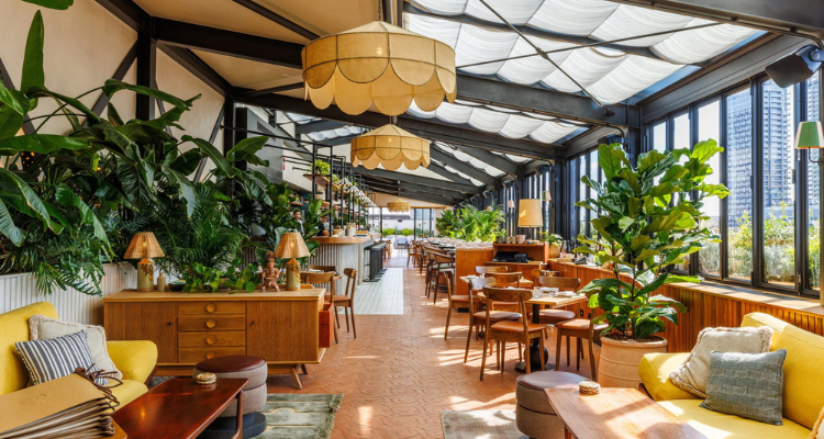 Yellow cushions, blue tiled flooring and brown gigantic lampshades: this big photo of Llama Inn London is a beauty.