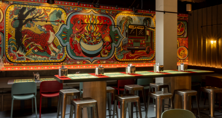 A picture of ADOH Central London's incredible interiors, fronting shades of crimson, gold and emerald.