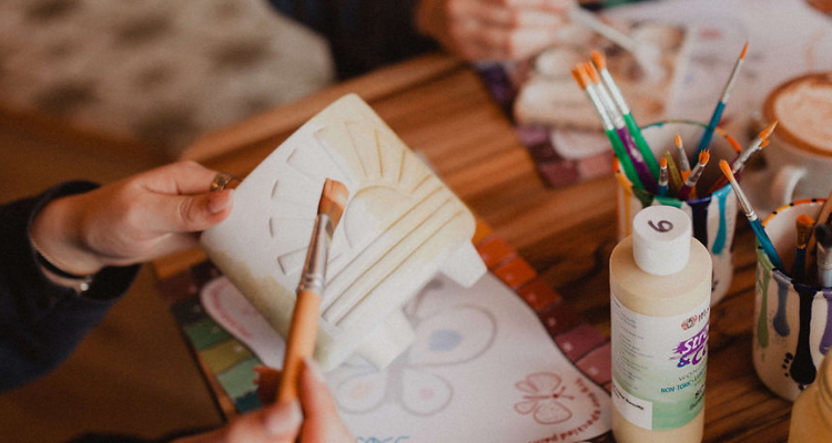 Bean and Brush Cafe people painting pots.