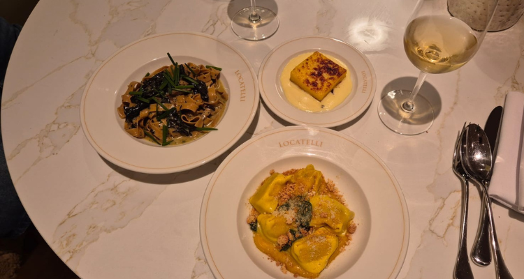 A picture of our table at Locatelli London, fronting plates of yellow pasta and a slab of polenta.