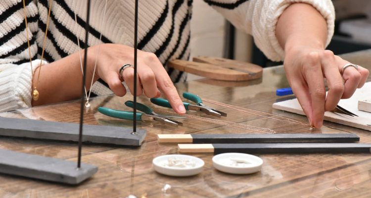 Someone making a necklace at The Ringsmiths in London.