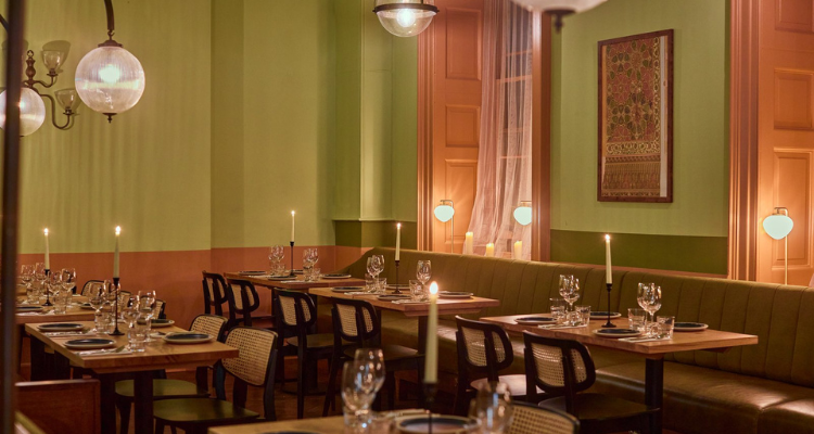 A picture of Aram's cosy, summery interiors, fronting green and peach colouring.
