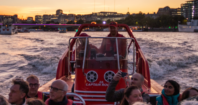 The Thames Lates boat on the river.