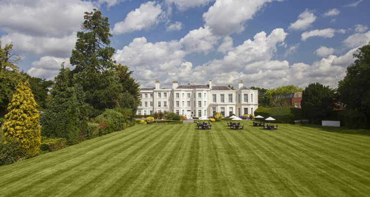 Exterior image of Burnham Beeches Hotel & Spa, featuring a grand country mansion and green grounds.