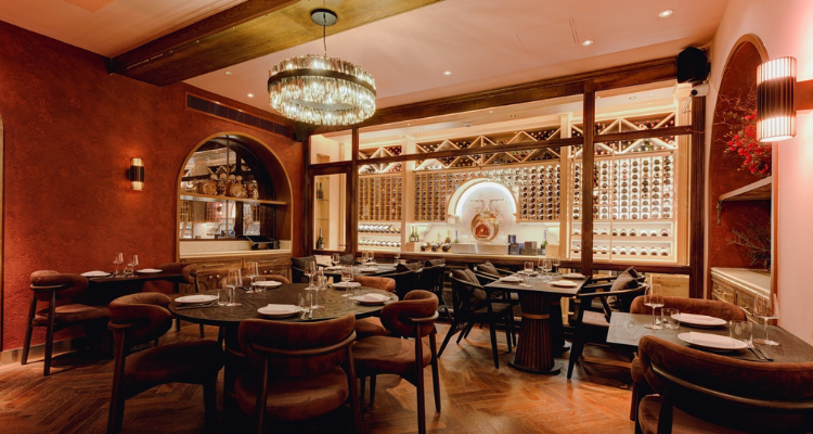 A picture of Chargal restaurant's stunning terracotta-like interiors, fronting glistening chandeliers.