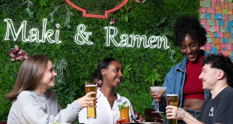 Two girls and a boy enjoying Maki & Ramen.