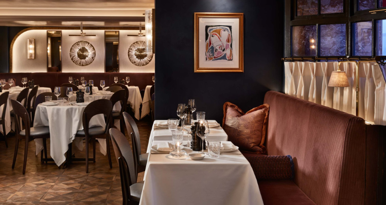 Interiors at Sale e Pepe, with dark walls and velvet seating.