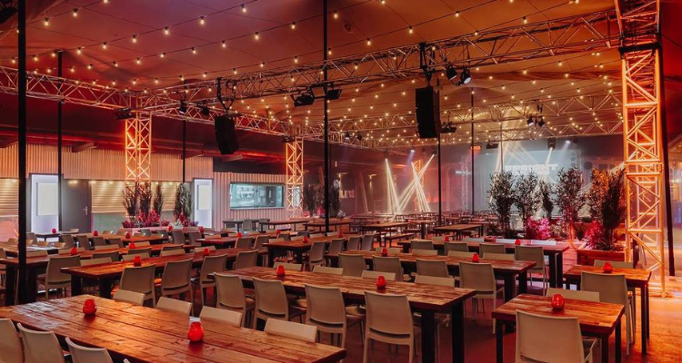 An image of Freight Brixton featuring long tables and a stage