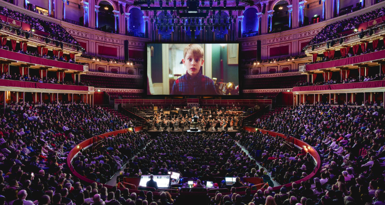 A screen featuring a young Macaulay Culkin from Home Alone in The Royal Albert Hall