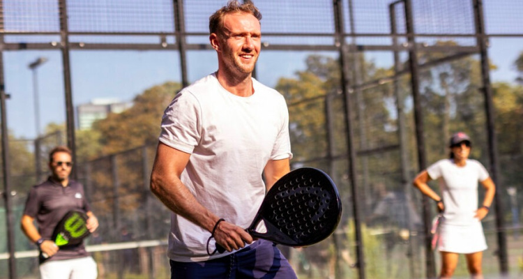 Two men and a woman taking part in padel drills at Lammas Park's padel courts.