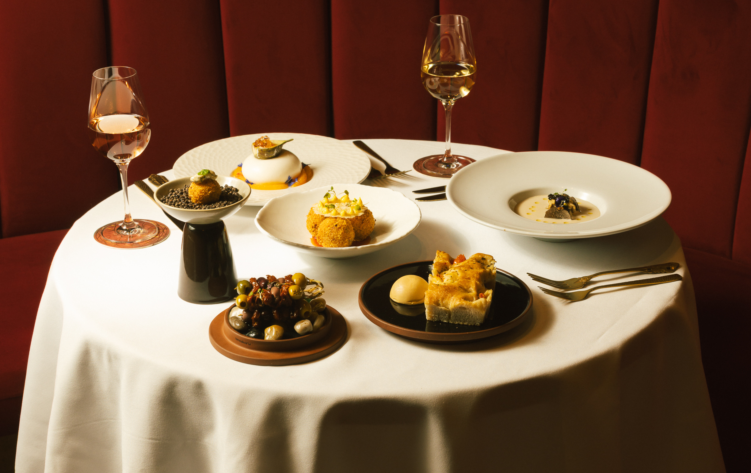 Table full of food and wine at Baloci Birmingham.