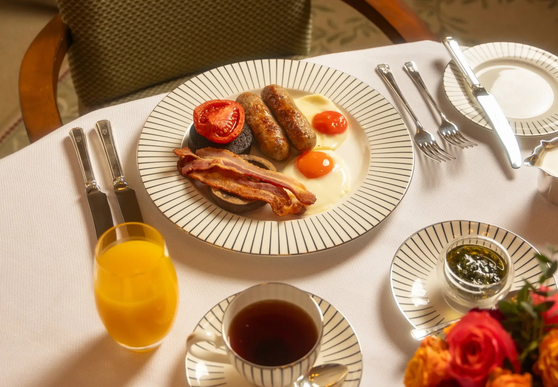 Michelin star breakfast at The Goring, including sausages, eggs, bacon, tomato, and black pudding.