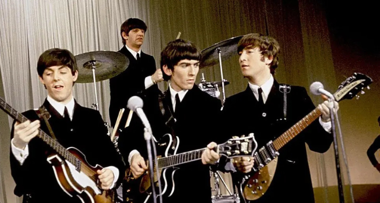 The four Beatles preforming a concert.