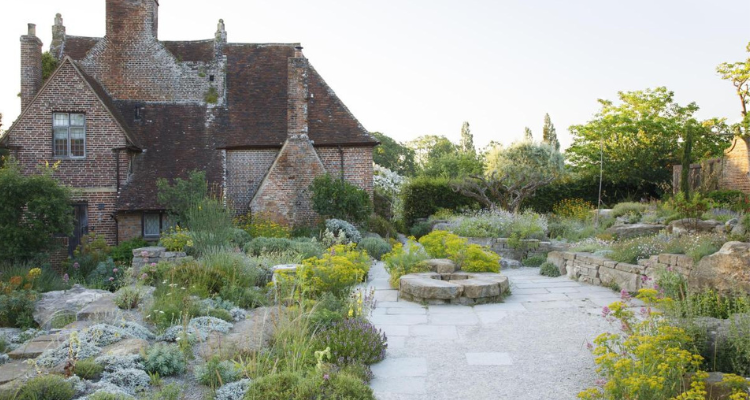 A brick building set in a well manicured garden.