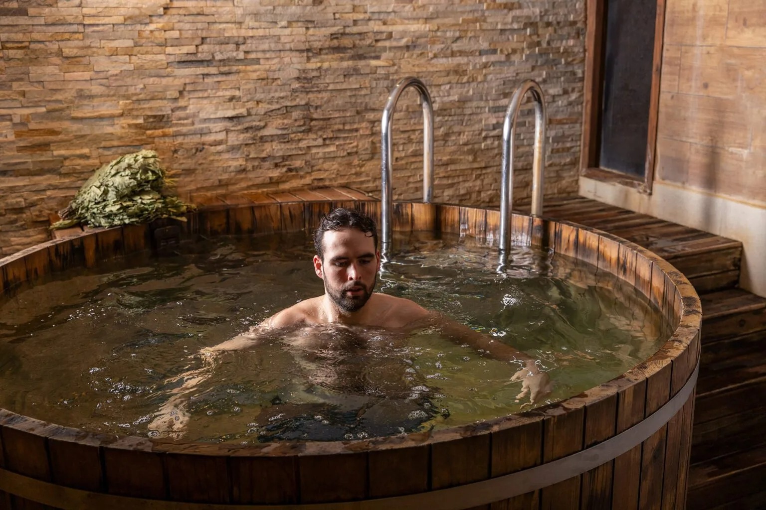 Man in a cold plunge pool at Banya No.1 Hoxton in London.