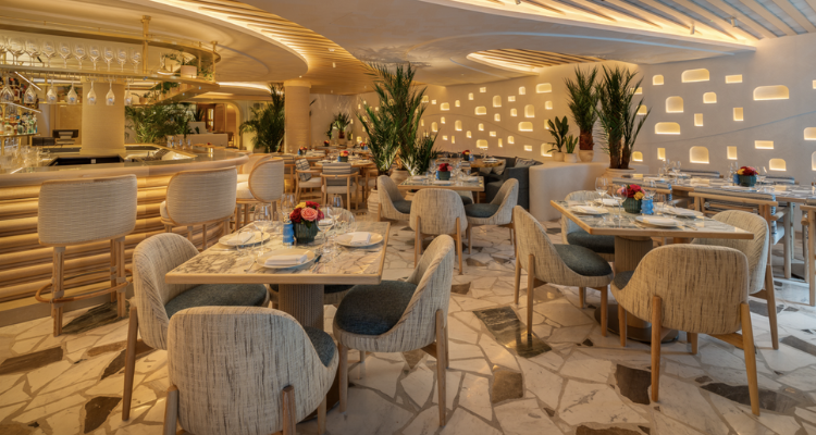 Interiors at Nammos, Mayfair, with white furniture and walls.
