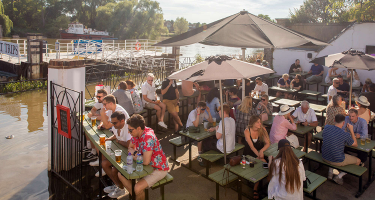 Guests sitting on the patio of The White Cross before it floods.