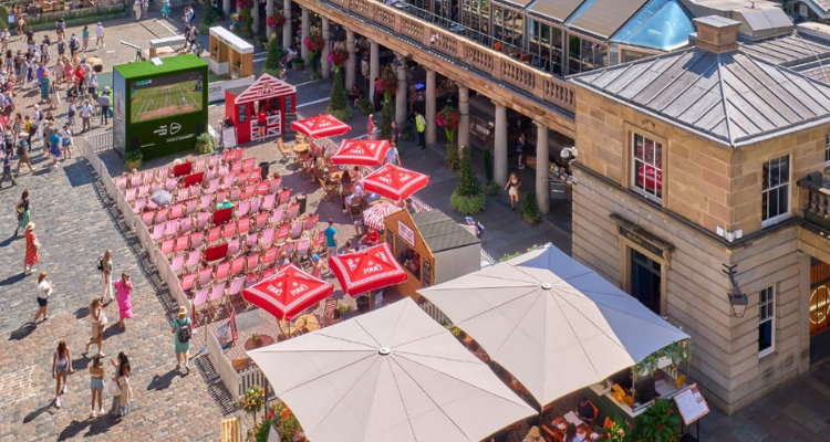 An open-air cinema in London's Covent Garden, surrounded by deck chairs.
