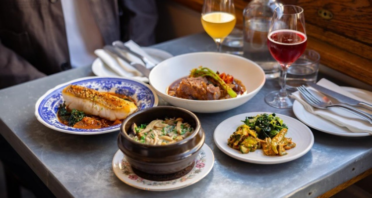 Dishes and wine laid out on a table at Calong in Stoke Newington.