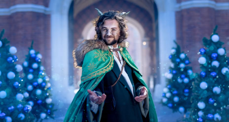 A mythical man with horns and a green cape with a fur trim reaches out. 