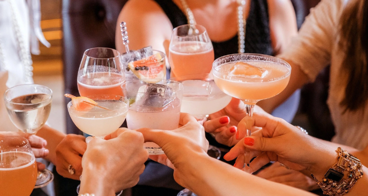 A group clinking glasses of gin and tonic at Love Jericho.