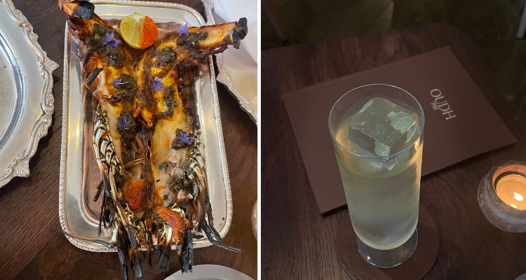 Prawn dish from OUDH 1722 and a cocktail with the menu on a table.