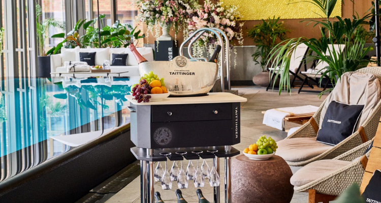 A luxury hotel pool with a Champagne trolley.