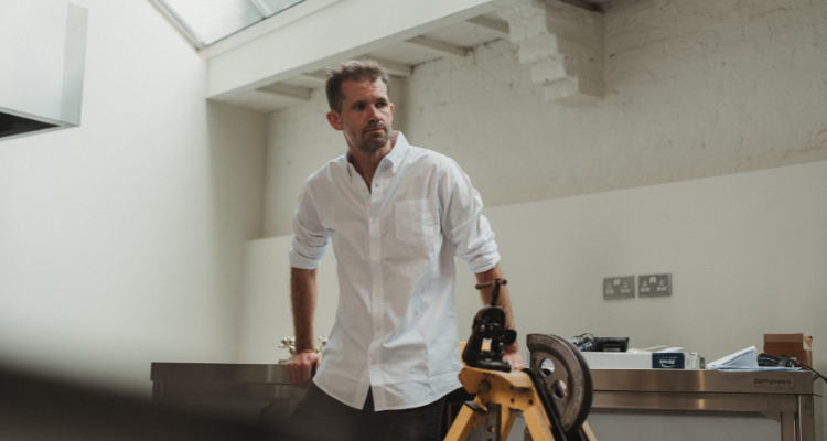 Gabriel Waterhouse standing behind a table.