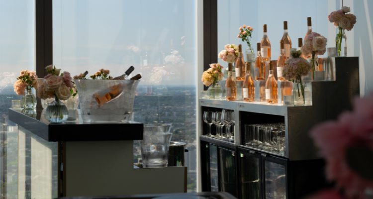 Bottles of Whispering Angel wine on a table next to a window overlooking London.