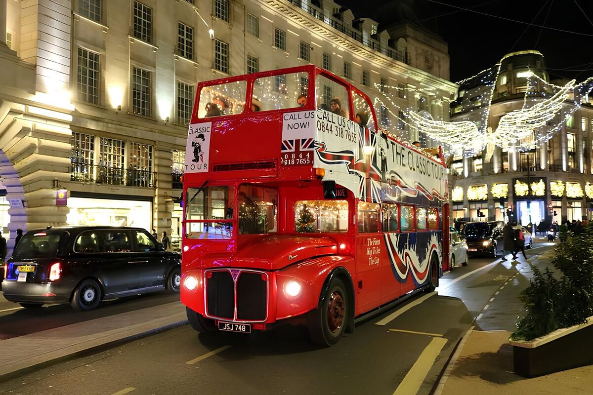An open-top double-decker bus touring London's Christmas lights.