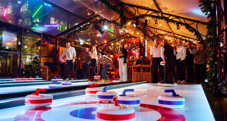 People curling at an indoor rink.
