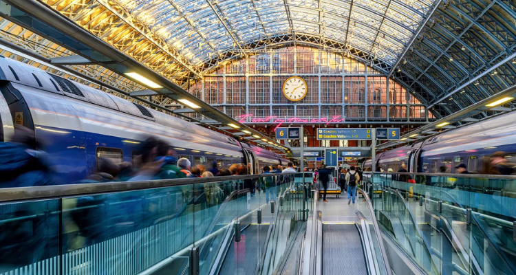 Two Eurostar trains inside a London train station.