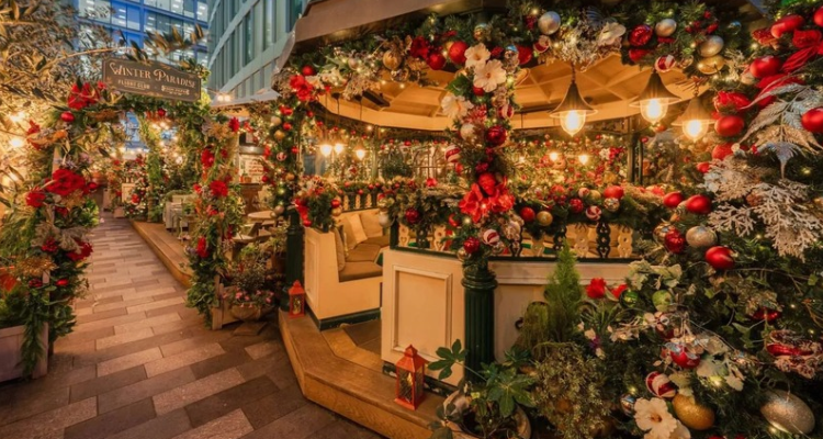 A Christmas rooftop with private cabins and fairy lights.