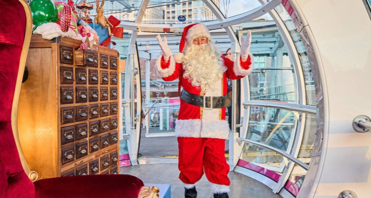 Santa surrounded by Christmas decorations in a London Eye pod.