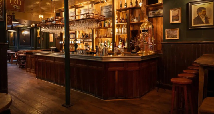 the low-lit interior of a classic British pub.